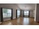Spacious living room featuring wood floors and lots of natural light through many windows at 804 Village Pl, Loganville, GA 30052