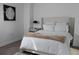 Bedroom features white bedding, silver nightstand, and neutral walls with decorative painting at 2870 Pharr Court South Nw # 2507, Atlanta, GA 30305