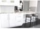 Modern kitchen featuring granite countertops, stainless steel appliances, and breakfast bar seating at 2870 Pharr Court South Nw # 2507, Atlanta, GA 30305