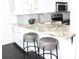 Kitchen with granite countertops, modern stools and stainless steel appliances at 2870 Pharr Court South Nw # 2507, Atlanta, GA 30305