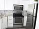 Well-lit kitchen features stainless steel appliances, white cabinetry and tile backsplash at 2870 Pharr Court South Nw # 2507, Atlanta, GA 30305