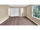 This bedroom features neutral walls, wood floors, and a view of the outside at 4701 Flat Shoals Road Rd # 37H, Union City, GA 30291