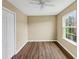 Bright bedroom with new flooring, a ceiling fan, and natural light through a large window at 4701 Flat Shoals Road Rd # 37H, Union City, GA 30291