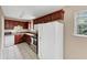 Functional kitchen featuring white appliances, dark cabinets, and tile flooring at 4701 Flat Shoals Road Rd # 37H, Union City, GA 30291