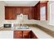 Cozy kitchen featuring stainless steel sink, microwave, and rich wood cabinetry for ample storage at 4701 Flat Shoals Road Rd # 37H, Union City, GA 30291