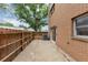 View of patio area with wooden fence, exterior brick wall and an AC unit at 4701 Flat Shoals Road Rd # 37H, Union City, GA 30291