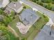 Aerial view showcasing a large backyard with a patio, fire pit, outdoor kitchen, and lush landscaping at 508 Highland Dr, Woodstock, GA 30188