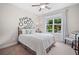 Bright bedroom with a full-sized bed and large window that overlooks a picturesque garden at 508 Highland Dr, Woodstock, GA 30188