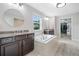 Well-appointed main bathroom featuring separate vanities, a soaking tub, and ample storage at 508 Highland Dr, Woodstock, GA 30188