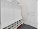 Organized mudroom with storage cubbies, hooks, a bench, and a doorway to the interior at 508 Highland Dr, Woodstock, GA 30188
