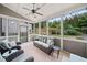 Inviting sunroom with ceiling fan, neutral furnishings, and views of the landscaped backyard at 508 Highland Dr, Woodstock, GA 30188