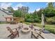 Inviting backyard patio featuring a stone fire pit, pergola-covered bar, and comfortable seating at 508 Highland Drive Dr, Woodstock, GA 30188