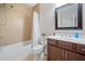 Well-lit bathroom featuring a tub-shower combo and wooden vanity at 508 Highland Drive Dr, Woodstock, GA 30188