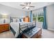 Bedroom with a ceiling fan, a large window with natural light, and a bench at the end of the bed at 508 Highland Drive Dr, Woodstock, GA 30188