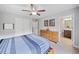 Bedroom featuring a ceiling fan, a dresser, and access to an en-suite bathroom at 508 Highland Drive Dr, Woodstock, GA 30188