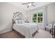 Cozy bedroom with natural light, a comfortable bed, and view of the landscaped yard at 508 Highland Drive Dr, Woodstock, GA 30188