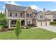 Beautiful home boasts manicured lawn and a three-car garage, enhancing its curb appeal at 508 Highland Drive Dr, Woodstock, GA 30188