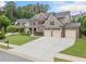 Stunning home with well-kept lawn, three-car garage, and lush greenery creating an inviting outdoor space at 508 Highland Drive Dr, Woodstock, GA 30188