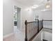 Upstairs hallway featuring wrought iron railing, natural light, and neutral wall paint at 508 Highland Drive Dr, Woodstock, GA 30188
