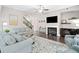 Bright and airy living room with a fireplace, ceiling fan, hardwood floors and plush sofas at 508 Highland Drive Dr, Woodstock, GA 30188
