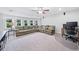 Spacious living room features a large sectional sofa, neutral carpet, and a ceiling fan at 508 Highland Drive Dr, Woodstock, GA 30188