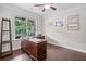 Cozy home office featuring a large wooden desk, natural light, and a peaceful setting at 508 Highland Drive Dr, Woodstock, GA 30188