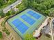 Aerial view of the community tennis courts, perfectly lined and surrounded by lush landscaping at 508 Highland Drive Dr, Woodstock, GA 30188