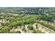 An aerial view shows the house nestled among trees in the neighborhood at 726 Sunset Ridge Ln, Lawrenceville, GA 30045