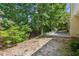 A peaceful patio sits on a mostly-wooded lot with mature trees providing shade at 726 Sunset Ridge Ln, Lawrenceville, GA 30045