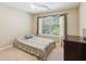 Bedroom featuring neutral walls, a ceiling fan, and a window at 726 Sunset Ridge Ln, Lawrenceville, GA 30045