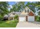 Charming home featuring a manicured lawn and a two-car garage, blending brick and siding for a classic look at 726 Sunset Ridge Ln, Lawrenceville, GA 30045
