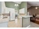 Bright kitchen with white cabinetry, modern appliances, and breakfast bar seating area at 726 Sunset Ridge Ln, Lawrenceville, GA 30045