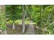 A stone path leads to a wooden staircase through a serene wooded area at 726 Sunset Ridge Ln, Lawrenceville, GA 30045