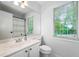 Bathroom features a sink with a large window, providing natural light and a refreshing ambiance at 802 Bluff Pl, Woodstock, GA 30188