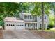 Charming two-story house with a three-car garage, a well-manicured lawn, and classic curb appeal at 802 Bluff Pl, Woodstock, GA 30188