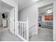 Hallway featuring view to bedrooms and staircase leads to a functional and well-lit space at 802 Bluff Pl, Woodstock, GA 30188