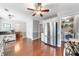 Open kitchen with stainless steel appliances, hardwood floors, and views into the dining area and laundry room at 802 Bluff Pl, Woodstock, GA 30188