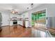 Bright kitchen with stainless steel appliances, wooden floors, white cabinets, and access to a patio at 802 Bluff Pl, Woodstock, GA 30188