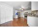 White kitchen features stainless steel appliances, hardwood floors, and ample storage space at 802 Bluff Pl, Woodstock, GA 30188