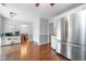Spacious kitchen featuring stainless steel appliances, hardwood floors, and ample storage at 802 Bluff Pl, Woodstock, GA 30188