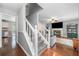 Open floor plan showcasing hardwood floors, staircase, and a living room with a fireplace at 802 Bluff Pl, Woodstock, GA 30188