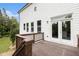 Cozy wooden back deck accessible through double doors, overlooking a green yard and trees at 25 Running Terrace Way, Cartersville, GA 30121
