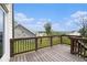 Wooden back deck offering scenic views of the surrounding neighborhood and blue sky at 25 Running Terrace Way, Cartersville, GA 30121