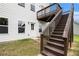 Rear exterior view with wooden staircase leading to a second-story deck and a door to the backyard at 25 Running Terrace Way, Cartersville, GA 30121