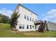 View of the backyard with a wooden deck with stairs, windows and a door that leads into the white home at 25 Running Terrace Way, Cartersville, GA 30121