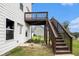 The backyard features a wooden deck with stairs and a door leading into the white home at 25 Running Terrace Way, Cartersville, GA 30121