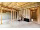 Unfinished basement with exposed ceiling, framed walls, and concrete floor, ideal for customization at 25 Running Terrace Way, Cartersville, GA 30121