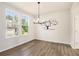 Dining area featuring hardwood floors, large windows, and modern chandelier lighting at 25 Running Terrace Way, Cartersville, GA 30121