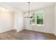 Bright dining room featuring wood-look floors, modern chandelier and large window offering natural light at 25 Running Terrace Way, Cartersville, GA 30121