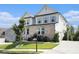 Attractive two-story home with a brick facade, white siding, a well-kept lawn, and a spacious driveway at 25 Running Terrace Way, Cartersville, GA 30121